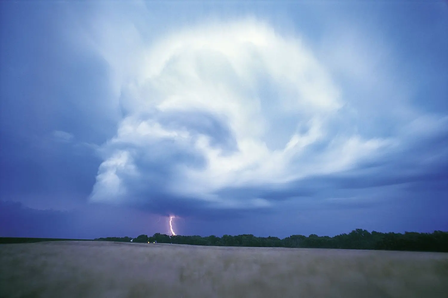 This is a photo of powerful tornado with lightning.