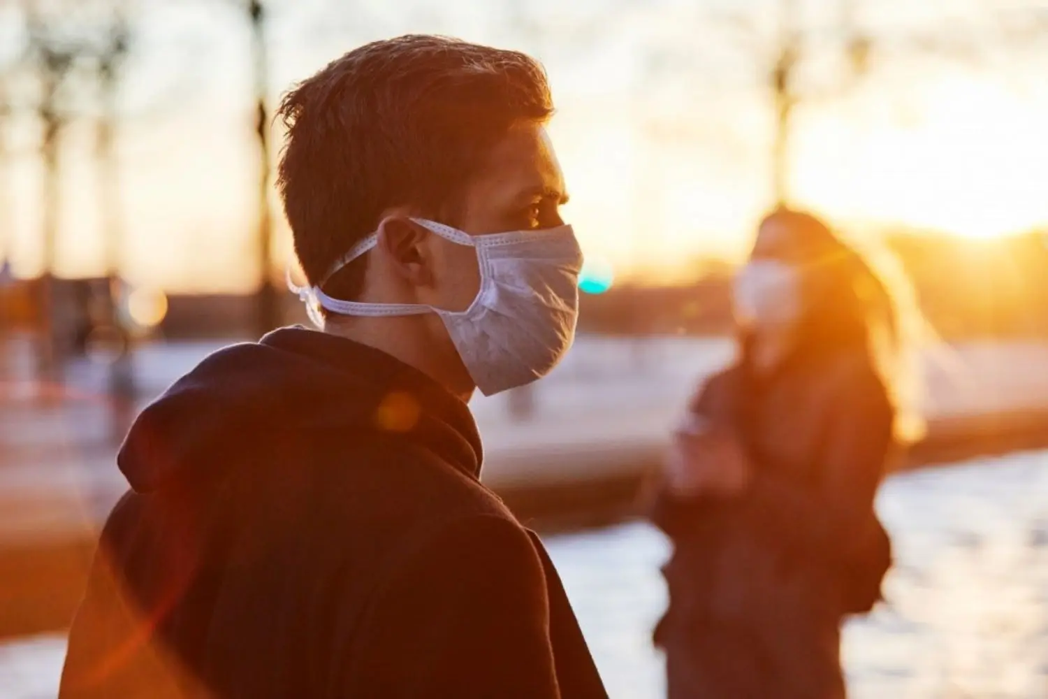 Man and woman wearing face masks.