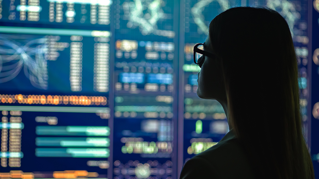 businesswoman in glasses standing near the display